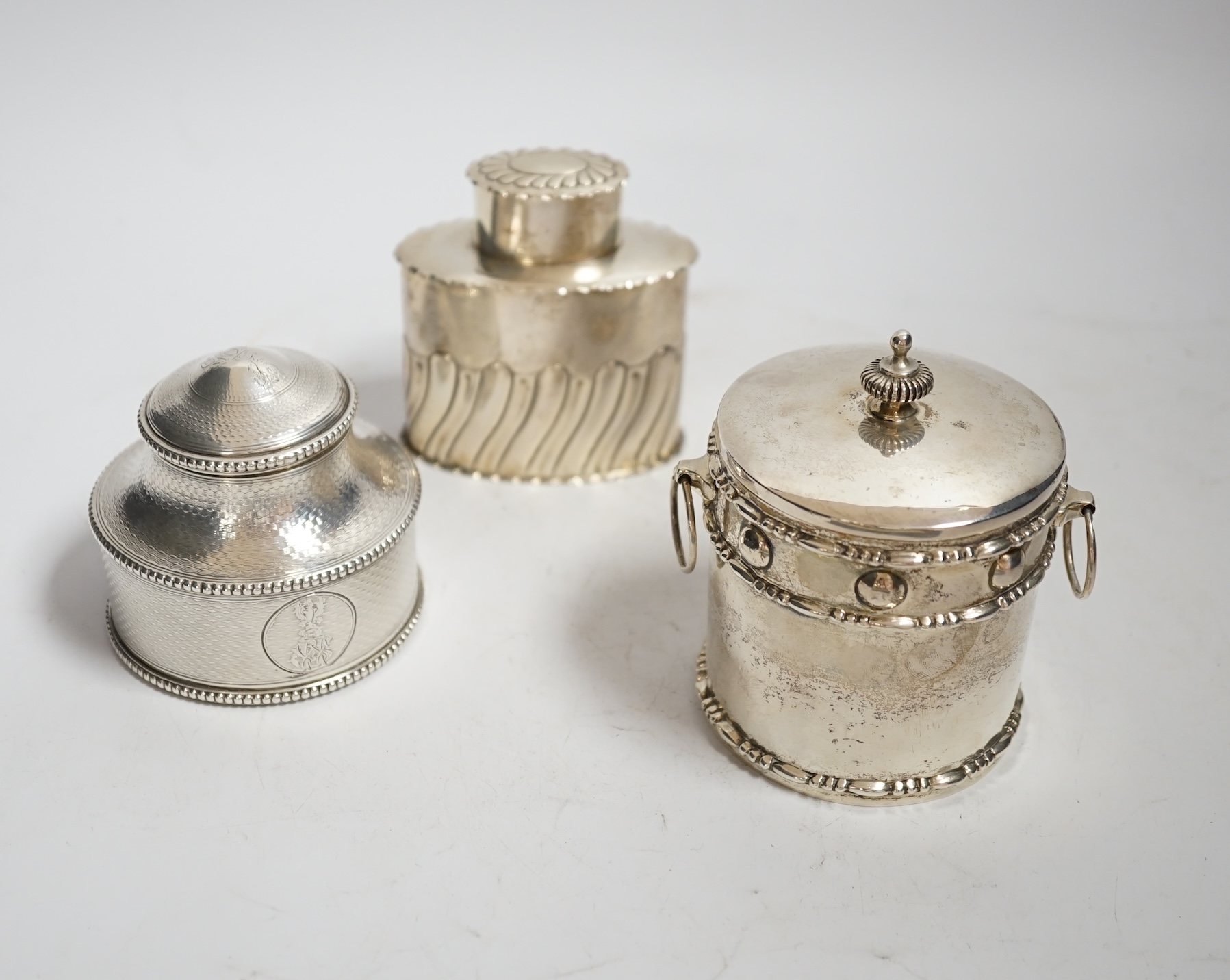 A Victorian engine turned silver circular tea caddy, William Shaw II, London, 1865, height 68mm, together with two other silver tea caddies, 14.8oz.